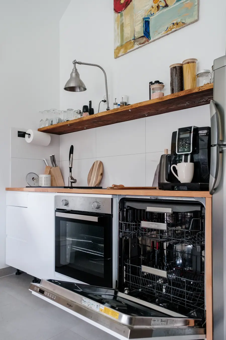 The kitchen worktop with the coffee machine, oven and dishwasher